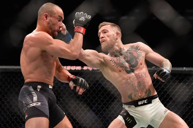 Conor McGregor landing a straight left punch on opponent during UFC lightweight title fight