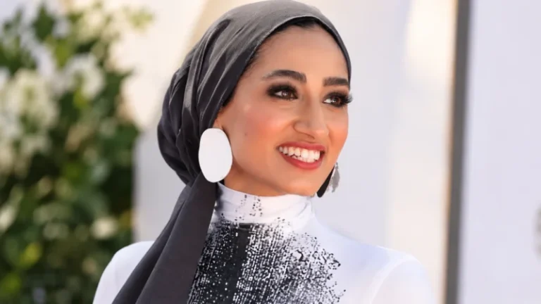 Zainab Jiwa in a gold hooded gown on a London premiere red carpet